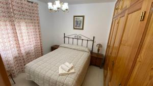 a bedroom with a bed with a towel on it at El enebrón - Hoces del río Duratón in Villar de Sobrepeña