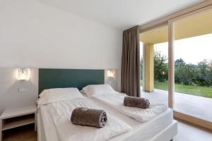 a bedroom with a large bed and a large window at Agriturismo Le Campagnole Green in Bardolino +14 photos