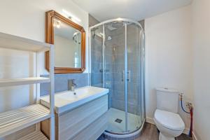 a bathroom with a shower and a sink and a toilet at Ker Breizh - Saint Pabu - 14 pers in Saint-Pabu