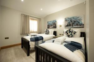 a bedroom with two beds and a window at Oak Lodge in Reading