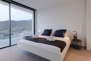Postel nebo postele na pokoji v ubytování Karat Villa Kai Torviscas + 9 fotografií