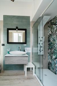 a bathroom with a tub and a sink and a mirror at Maison Salvia in Rome