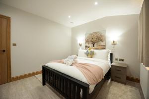 a bedroom with a bed with a teddy bear on it at Oak Lodge in Reading