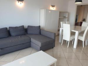 a living room with a couch and a table at Les Jardins de Monaco in Cap d'Ail +5 photos