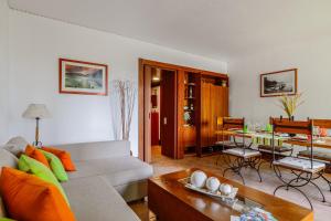 a living room with a couch and a table at Sunset Troia Beach in Troia