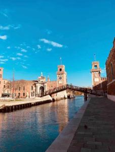 a bridge over a river in front of a building at Cozy apartment close to Biennale of Venice in Venice