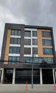 a tall building with a lot of windows at Modelia Living & Parking SAS in Bogotá