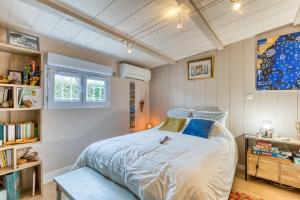 a bedroom with a large bed with blue pillows at Maison pour 6 entre Vignes et Mer in Marseillan +21 photos