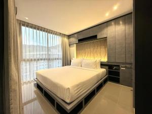 Postel nebo postele na pokoji v ubytování Citygate Kamala Resort + 15 fotografií