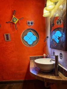 a bathroom with a white sink and two mirrors at Casa Amor Por Siempre in Bucerías