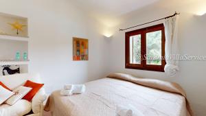 Ένα ή περισσότερα κρεβάτια σε δωμάτιο στο Villa Abbaiola - Porto Cervo Marina +37 φωτογραφίες