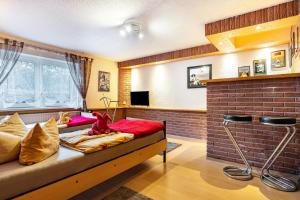 a room with a bed and a brick wall at Große Ferienwohnung mit Garten in Trollenhagen