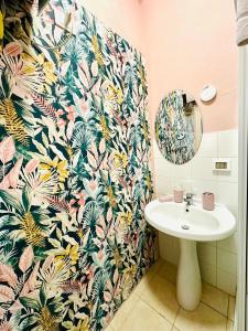 a bathroom with a sink and a tropical wallpaper at Casa Lilla in Monreale +73 photos