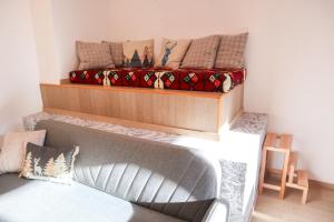 a living room with a couch and a bed at Cervo Felice Apartment in Belluno