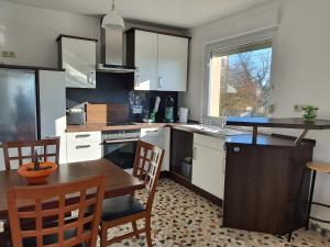 a kitchen with a table and a dining room at Pension Katja in Zweibrücken