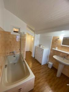 a large bathroom with a tub and a sink at Maison Ascain 10 personnes au pied de la Rhune, proche St Jean de Luz in Ascain