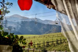 a view of a ski lift with mountains in the background at U Pabinów in Kościelisko