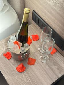 a bottle of wine and two glasses on a table at Dom João Glamour Hotel in Lisbon