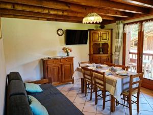 a kitchen and dining room with a table and chairs at Chalet Genépi in Le Grand-Bornand