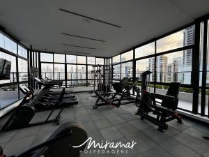 a gym with treadmills and machines in a building at Move - Tambaú in João Pessoa