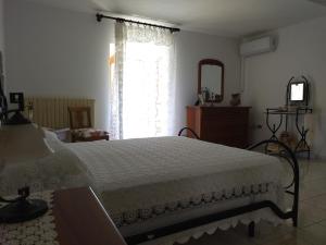 a bedroom with a large bed and a window at A Casa di Marietta in Ari