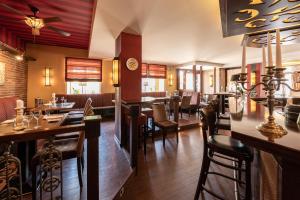 a restaurant with a bar and tables and chairs at Dagstuhler Hof in Wadern