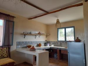 a kitchen with a refrigerator and a counter top at le Doux refuge 2 in Essaouira +35 photos