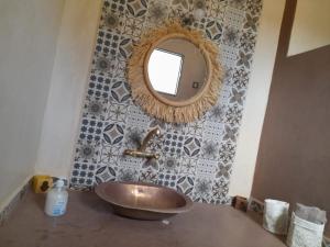 a bathroom with a sink and a mirror on a wall at le Doux refuge 2 in Essaouira