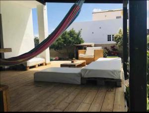 a bed on a wooden deck with a hammock at Villa Ballena in Lajares +32 photos