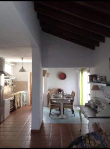 a kitchen and dining room with a table in it at Villa Ballena in Lajares