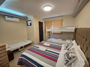 a hospital room with a bed and a crib at Primerose Manor - Near Mactan Airport & Beaches in Pajak +13 photos