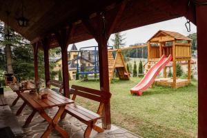 a playground with a bench and a slide at Chata Hana Donovaly in Donovaly