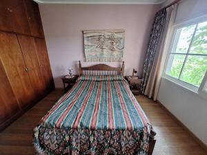 a bedroom with a bed with a colorful bedspread at San Ignacio cattle farm Magdalena Buenos Aires in Estación Ignacio Correas