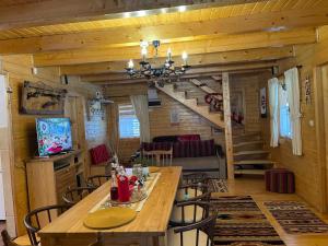 a dining room with a table and a staircase at Casa Dani in Vatra Dornei