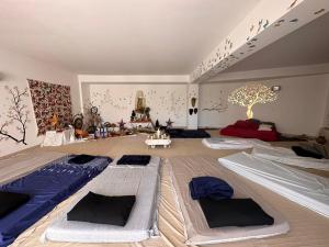 a room with several beds in the middle of it at Appartamento Venere in villa 18pax in Marina di Ragusa +19 photos