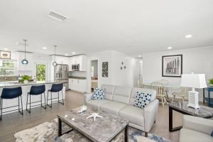a living room with a couch and a table at Ocean Breeze by Sun Palace Vacations in Fort Myers Beach