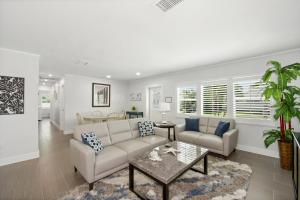 a living room with a couch and a table at Ocean Breeze by Sun Palace Vacations in Fort Myers Beach