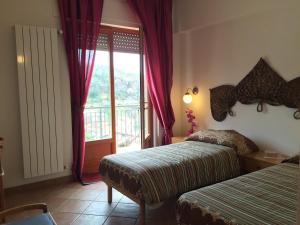 Ein Bett oder Betten in einem Zimmer der Unterkunft Villa Ettorina casa vacanze - appartamenti short stay