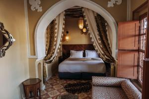 Postel nebo postele na pokoji v ubytování Riad Ksar Al Amal & Spa