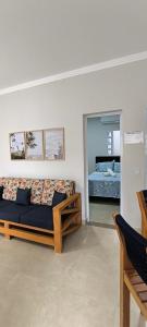 a bedroom with a bed and a mirror at Chales Aconchego JN in Bertioga +111 photos