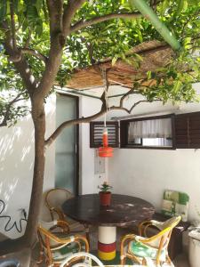 a patio with a table and chairs under a tree at Apartman Karla in Makarska