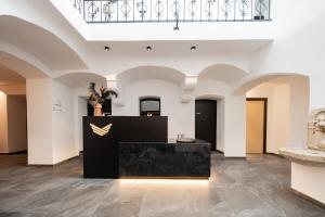 a gallery with a black counter in the middle of a room at Schwarzer Adler - Concept Living in Vipiteno