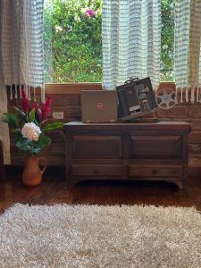 a room with a desk with a laptop computer and a window at La Cabaña del Abuelo in Lourdes