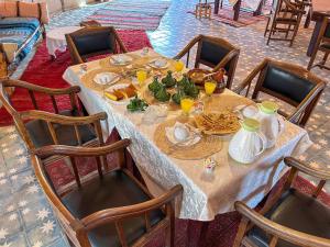 a table with food and drinks on top of it at Jardin Kotori Luxury Camp in Merzouga +60 photos