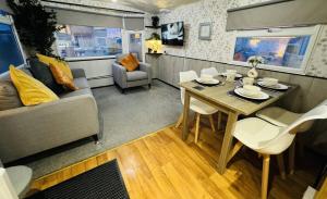 a living room with a table and a couch at Golden Sands Holiday Home in Skegness +29 photos