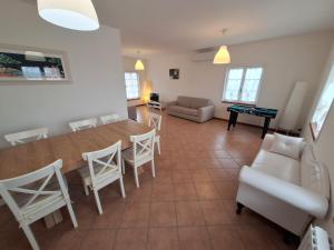 a living room with a table and chairs and a couch at Conero Cottage in Porto Recanati