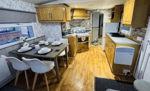 a small kitchen with a table and chairs in it at Golden Sands Holiday Home in Skegness