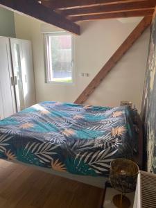 a bedroom with a bed with a colorful blanket at La Jarria in Jurançon +21 photos