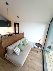 a living room with a white couch and a table at Bosque Cipreses Sur in San Carlos de Bariloche