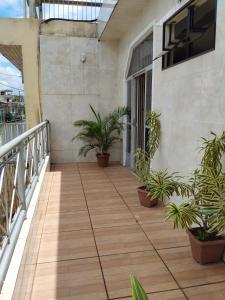 a balcony with potted plants on a building at Casa hospedagem COP 30 3 quartos 01 suíte in Belém